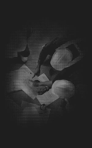 A black and white edited image of construction crew overlooking blueprint