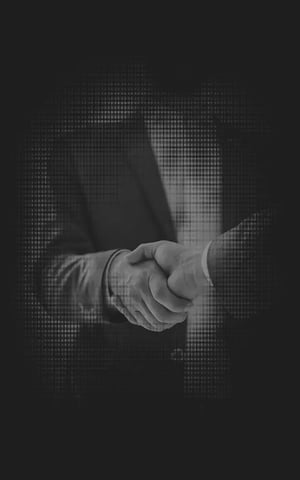 A black and white edited image of two people handshaking